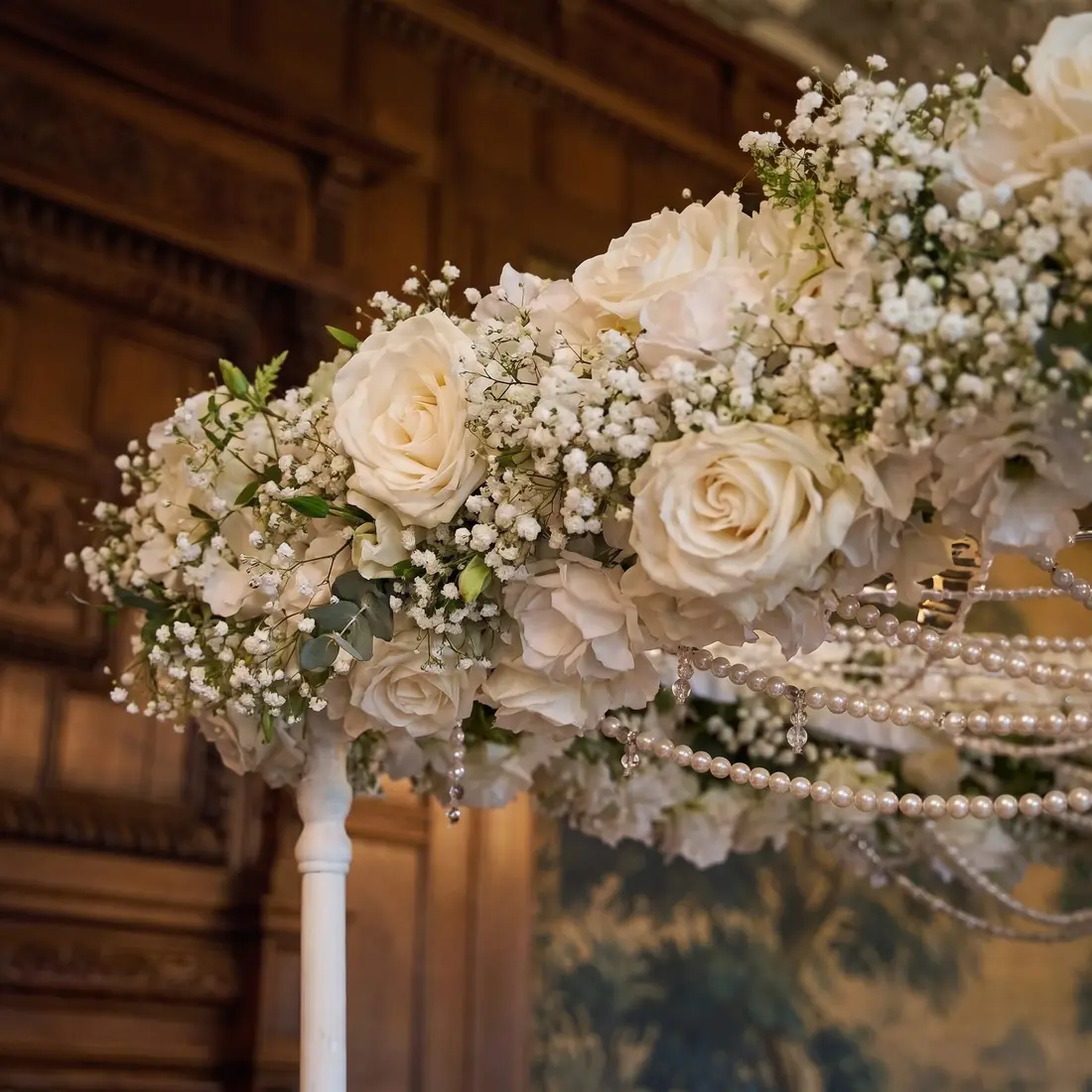Close-up detail of the Kiara canopy: white roses, baby's-breath and cascading pearls