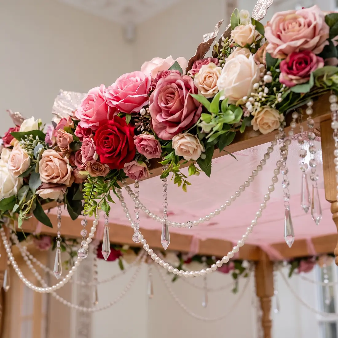 Close-up detail of The Secret Garden canopy: pink roses, butterflies, pearls and trailing greenery